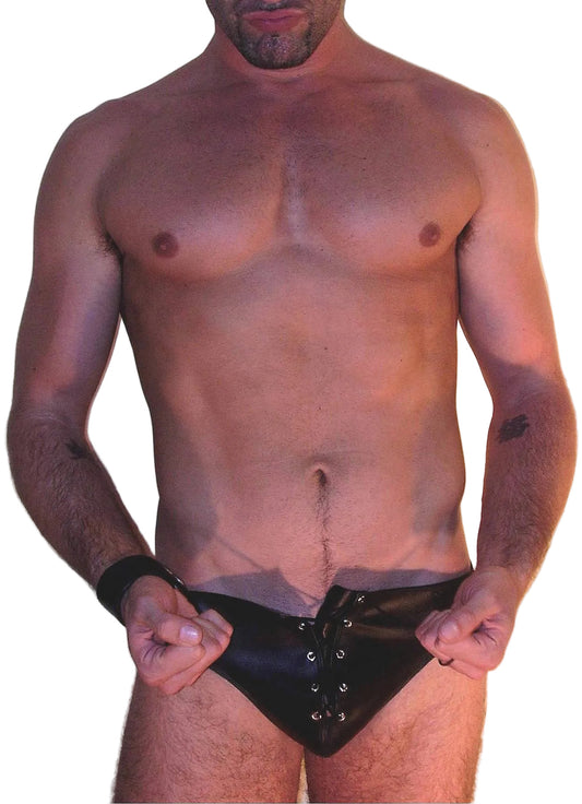 Man wearing a black satin thong against a plain background