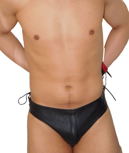 Person wearing black swim briefs with a white background