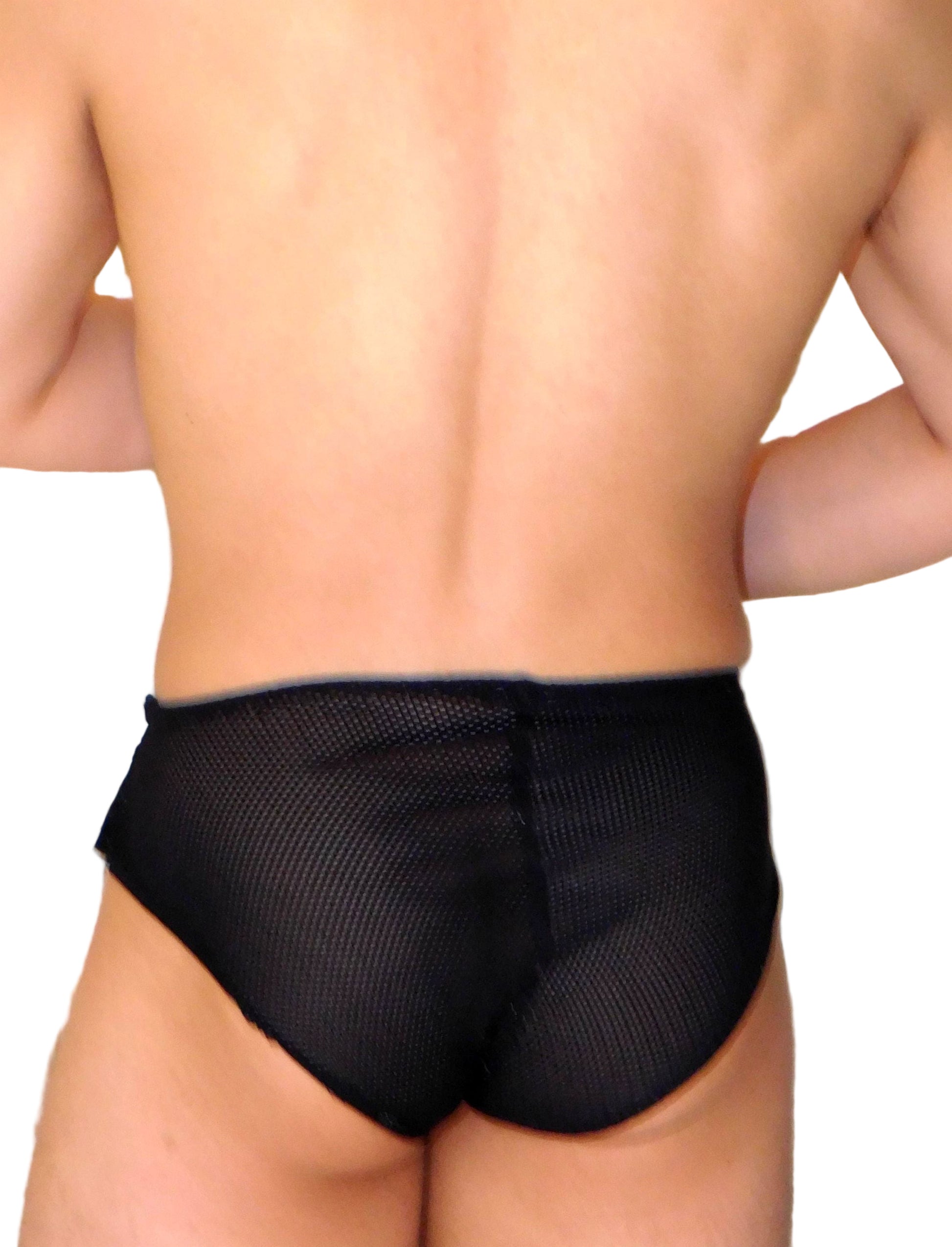 Person wearing black fishnet underwear against a neutral background